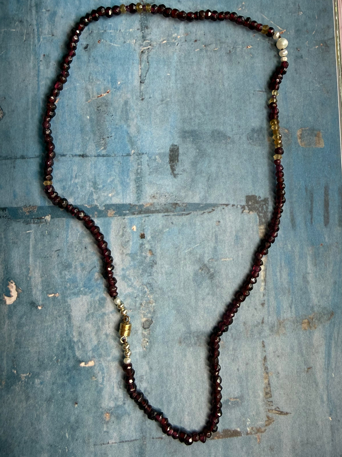 Hand cut garnets knotted on chocolate thread interspersed with freshwater pearls and citrine