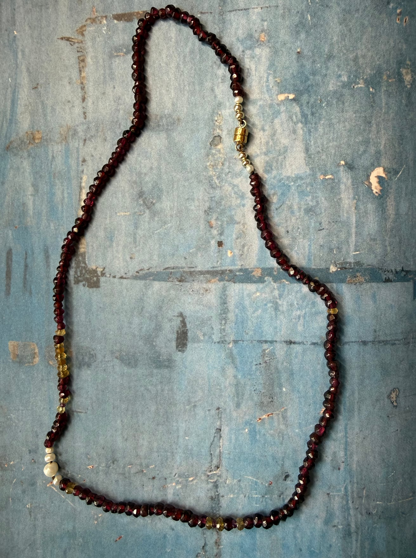 Hand cut garnets knotted on chocolate thread interspersed with freshwater pearls and citrine